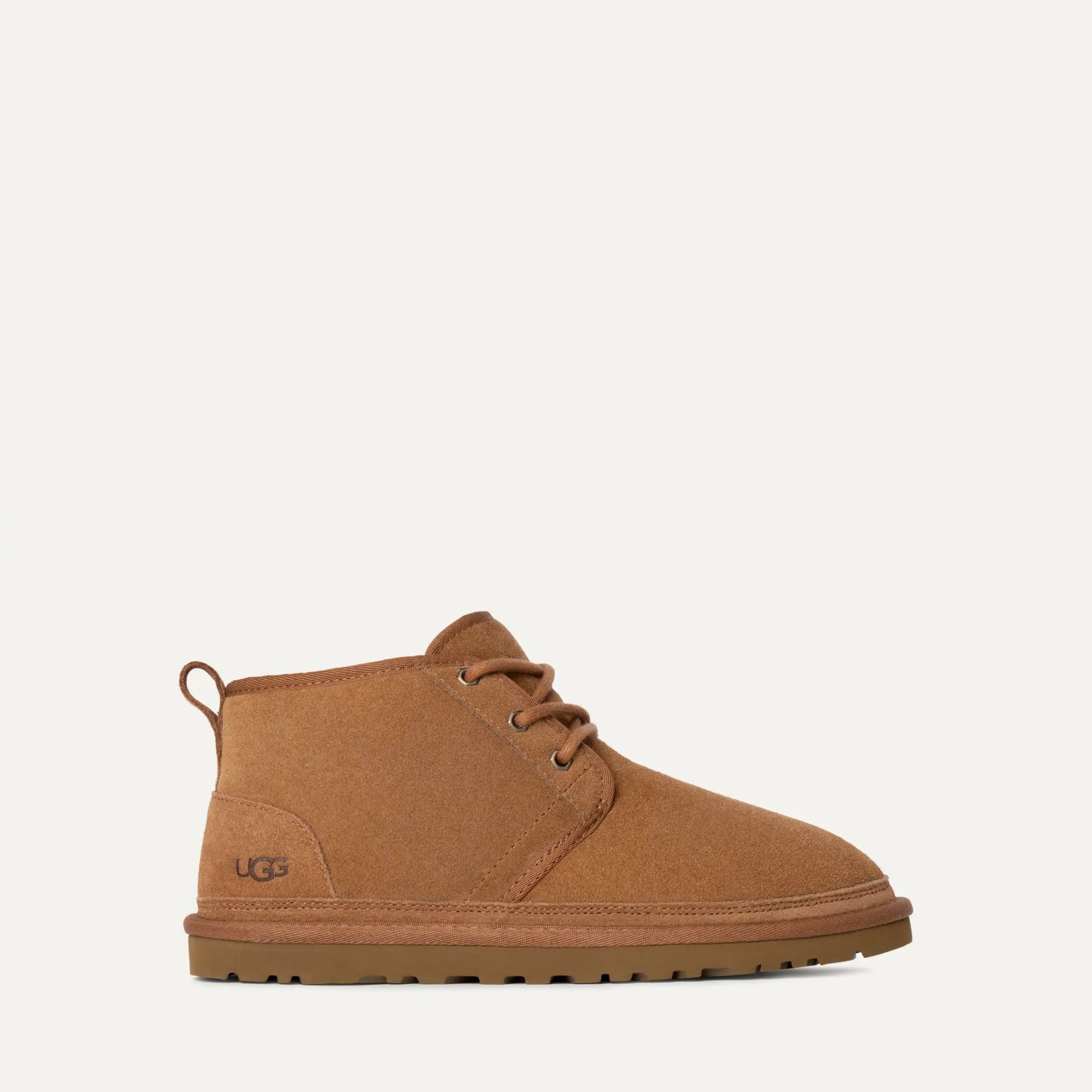Brown UGG boot on a light beige background