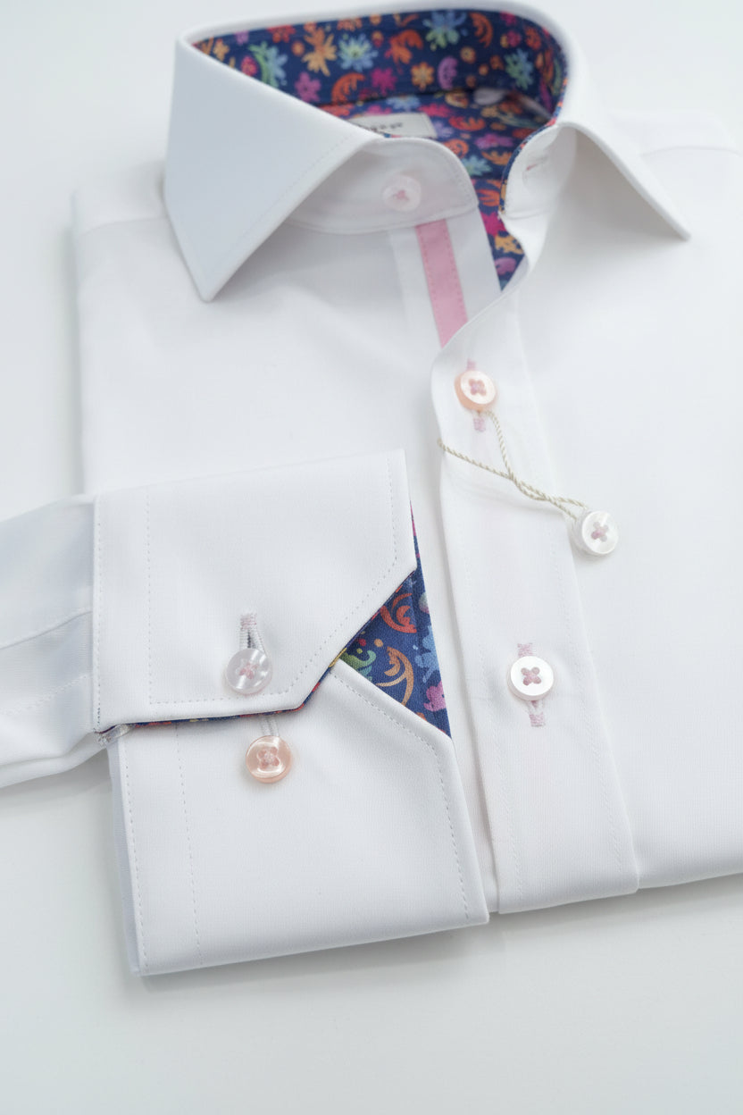 White dress shirt with cufflinks on a wooden surface