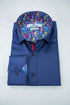 Blue dress shirt with floral pocket square and colorful lining on a wooden surface