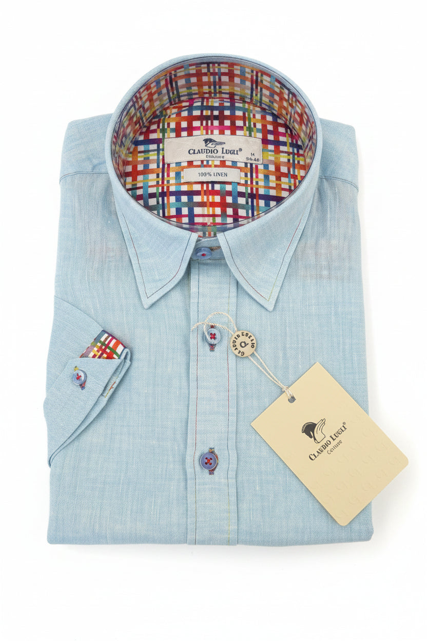 Mint dress shirt with colorful plaid interior on a wooden surface