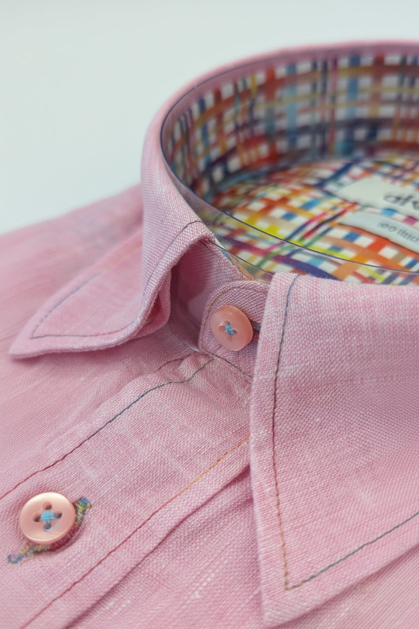 Close-up of a pink shirt collar with colorful interior lining.