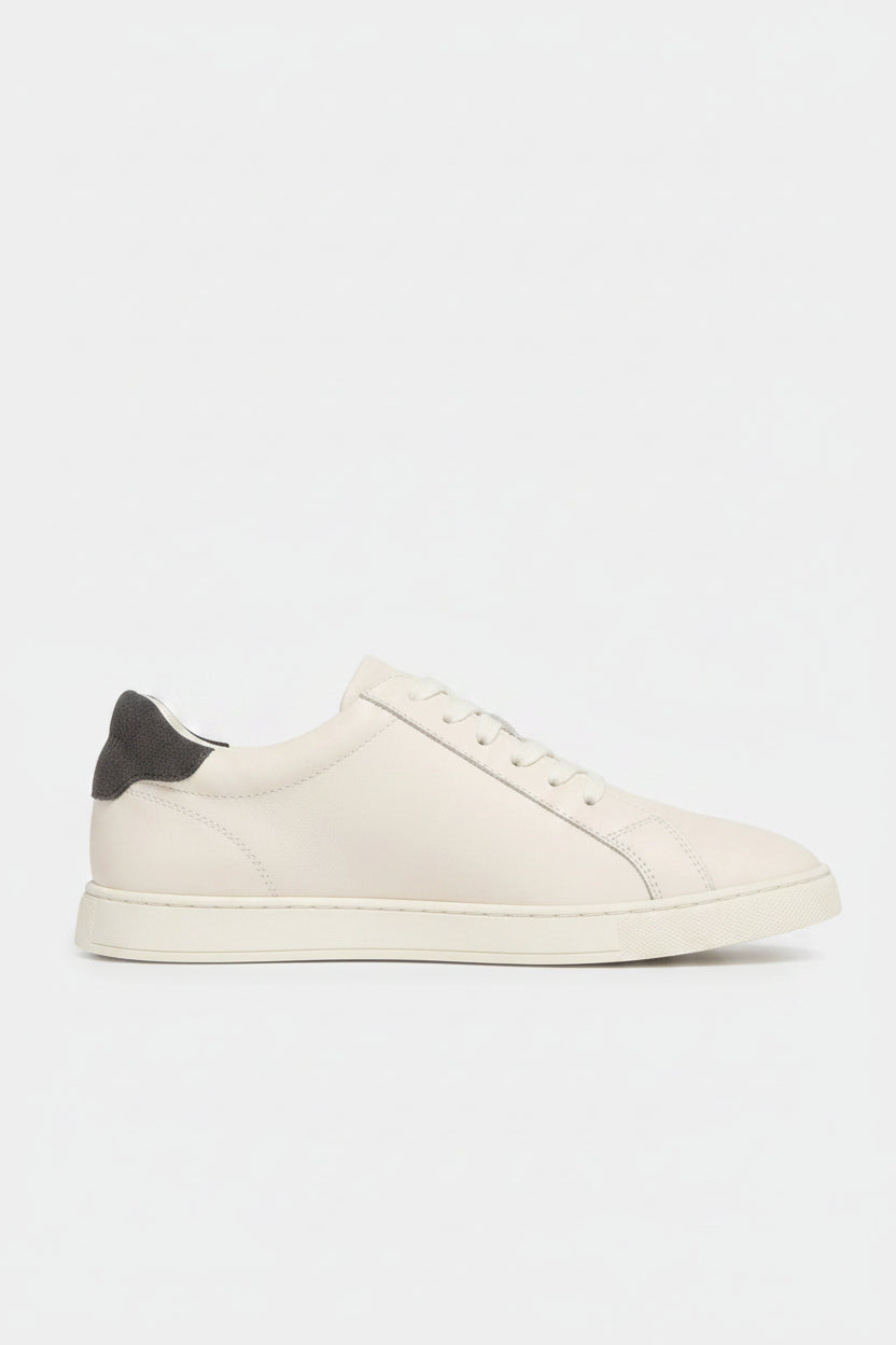 Cream sneaker with grey accents on a white background