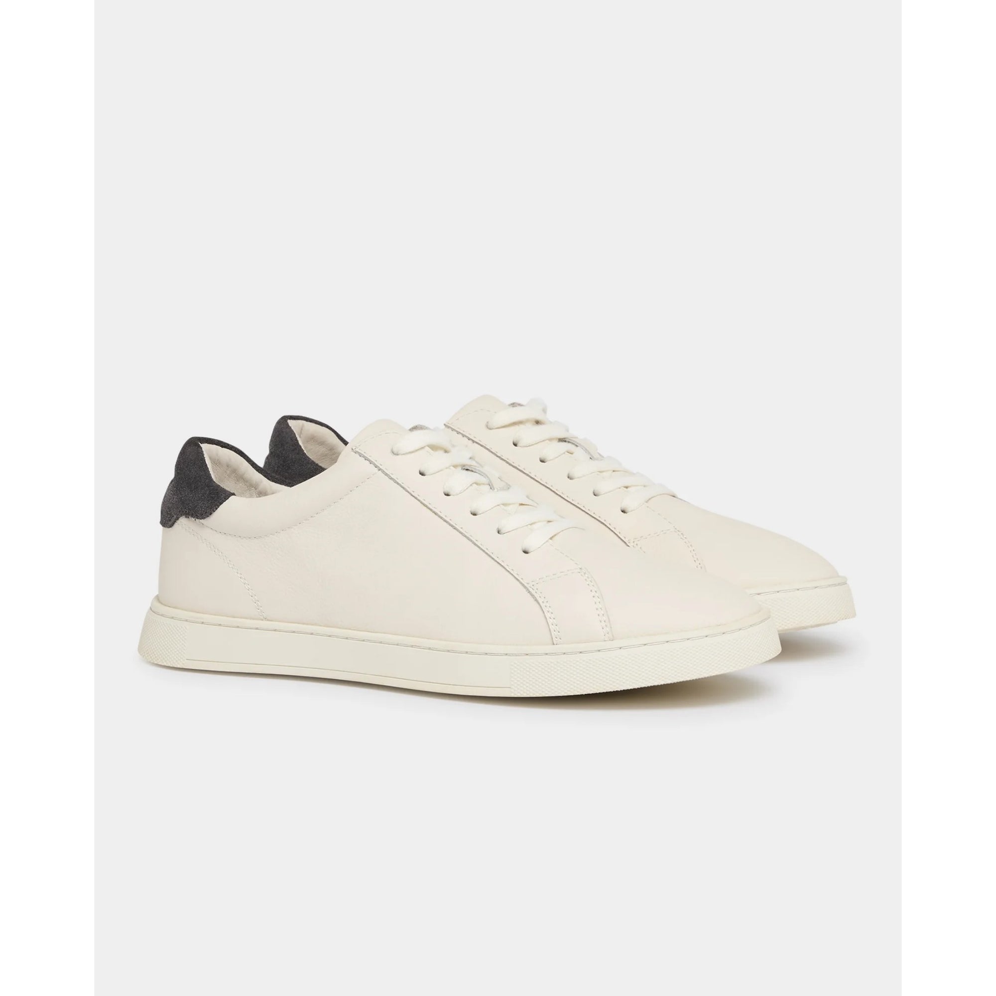 Cream sneaker with grey accents on a white background