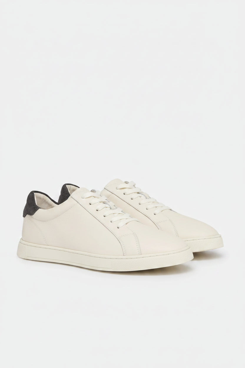 Cream sneaker with grey accents on a white background