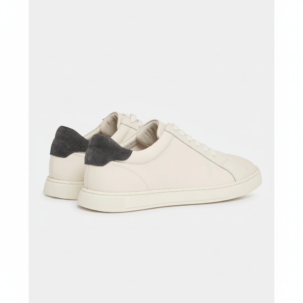 Cream sneaker with grey accents on a white background