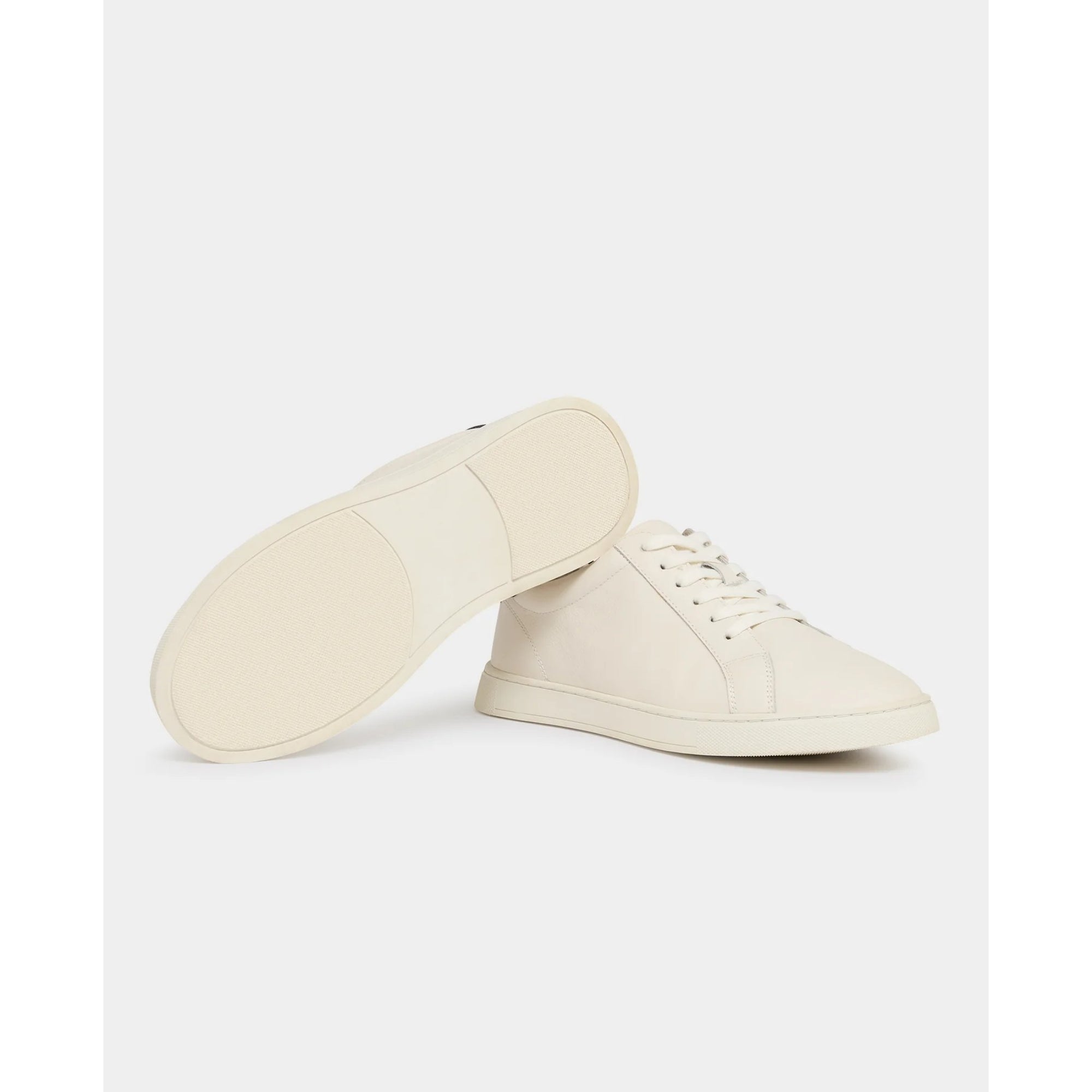 Cream sneaker with grey accents on a white background