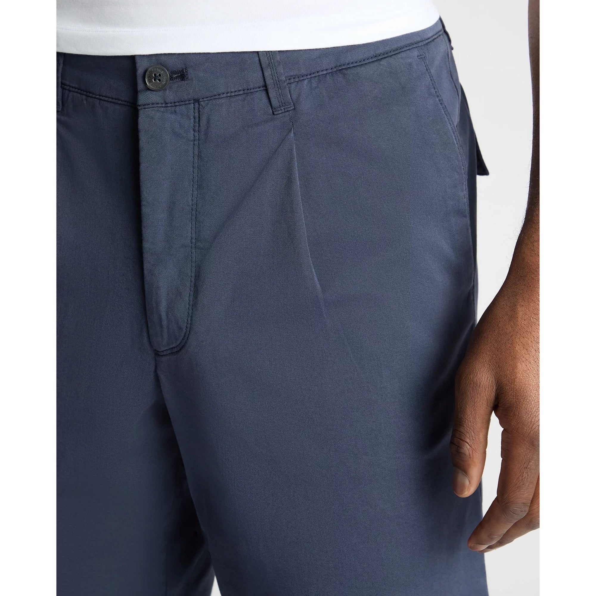 Navy blue pants worn by a person on a white background