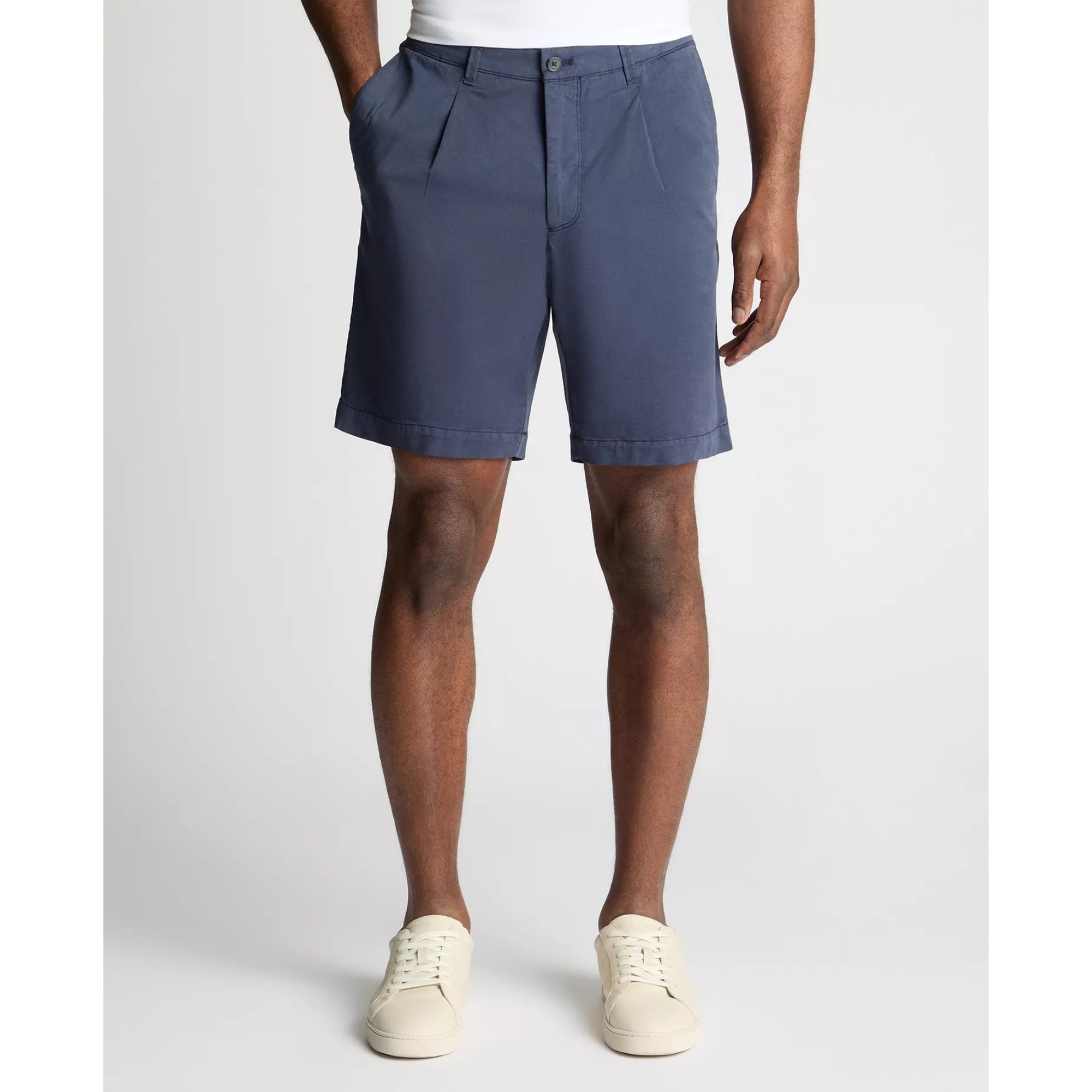 Person wearing blue shorts on a white background