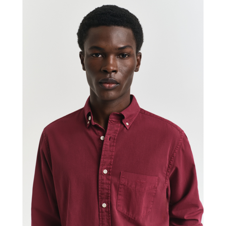 Man wearing a GANT maroon shirt against a plain background