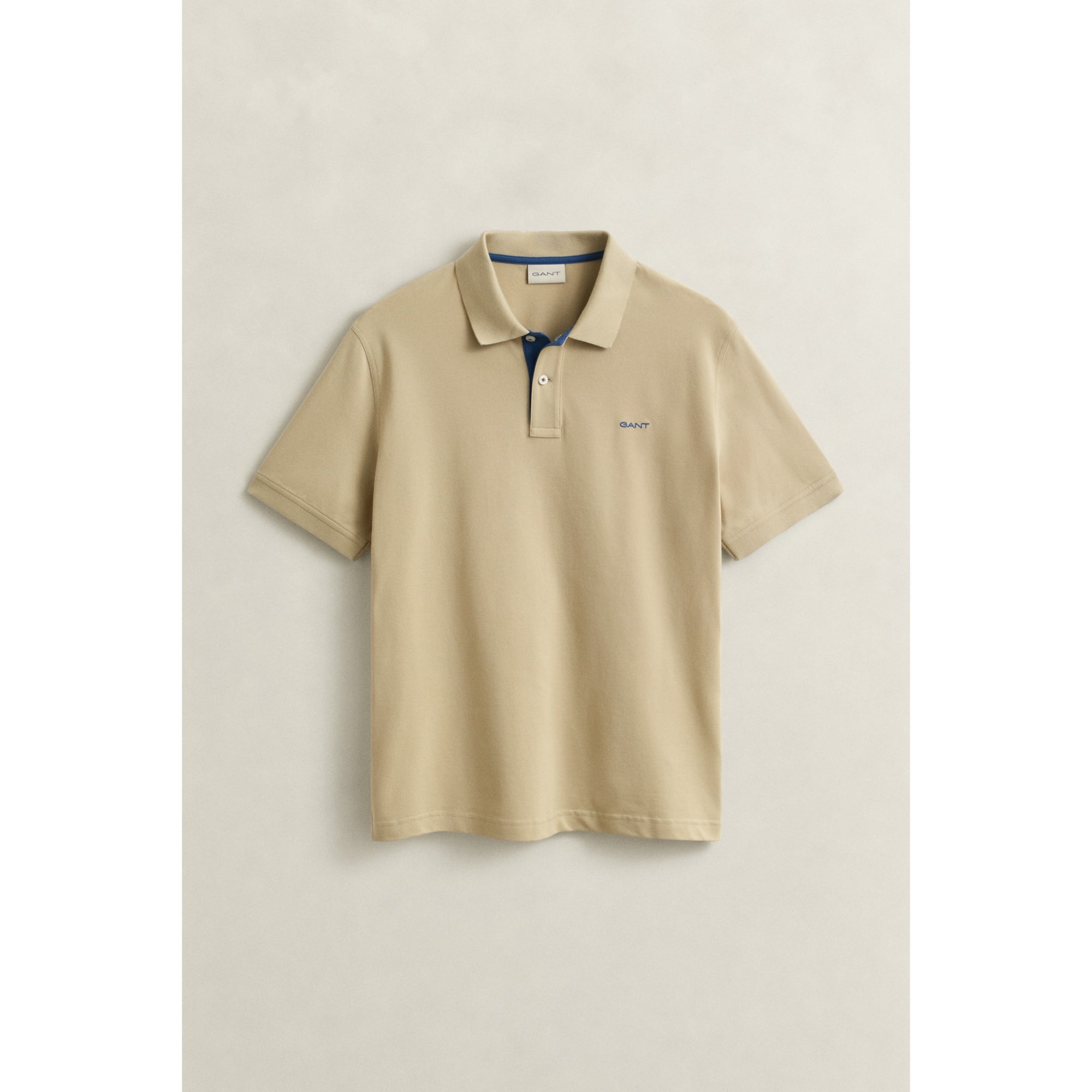 Beige polo shirt on a light beige background