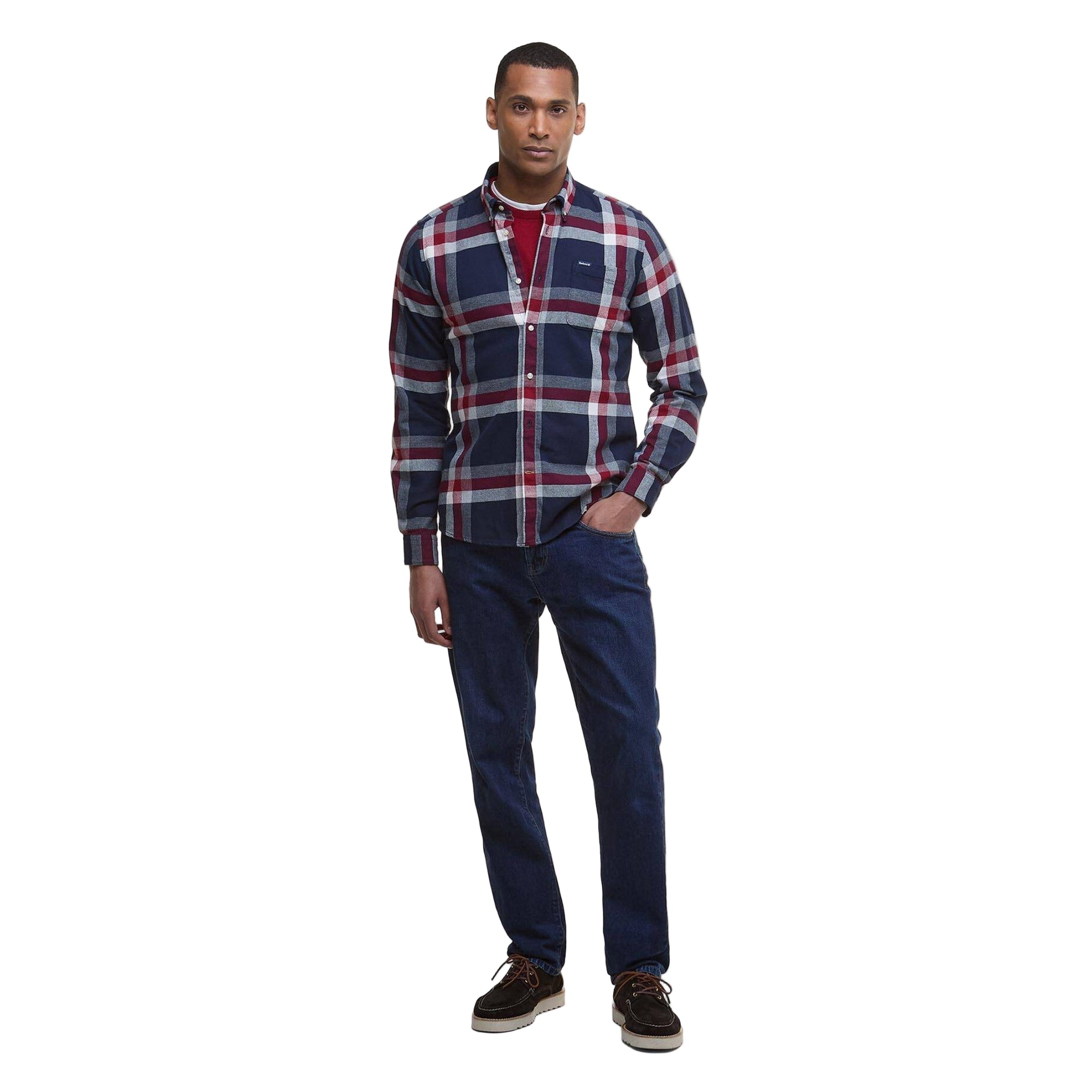 Man wearing a plaid shirt and jeans on a white background