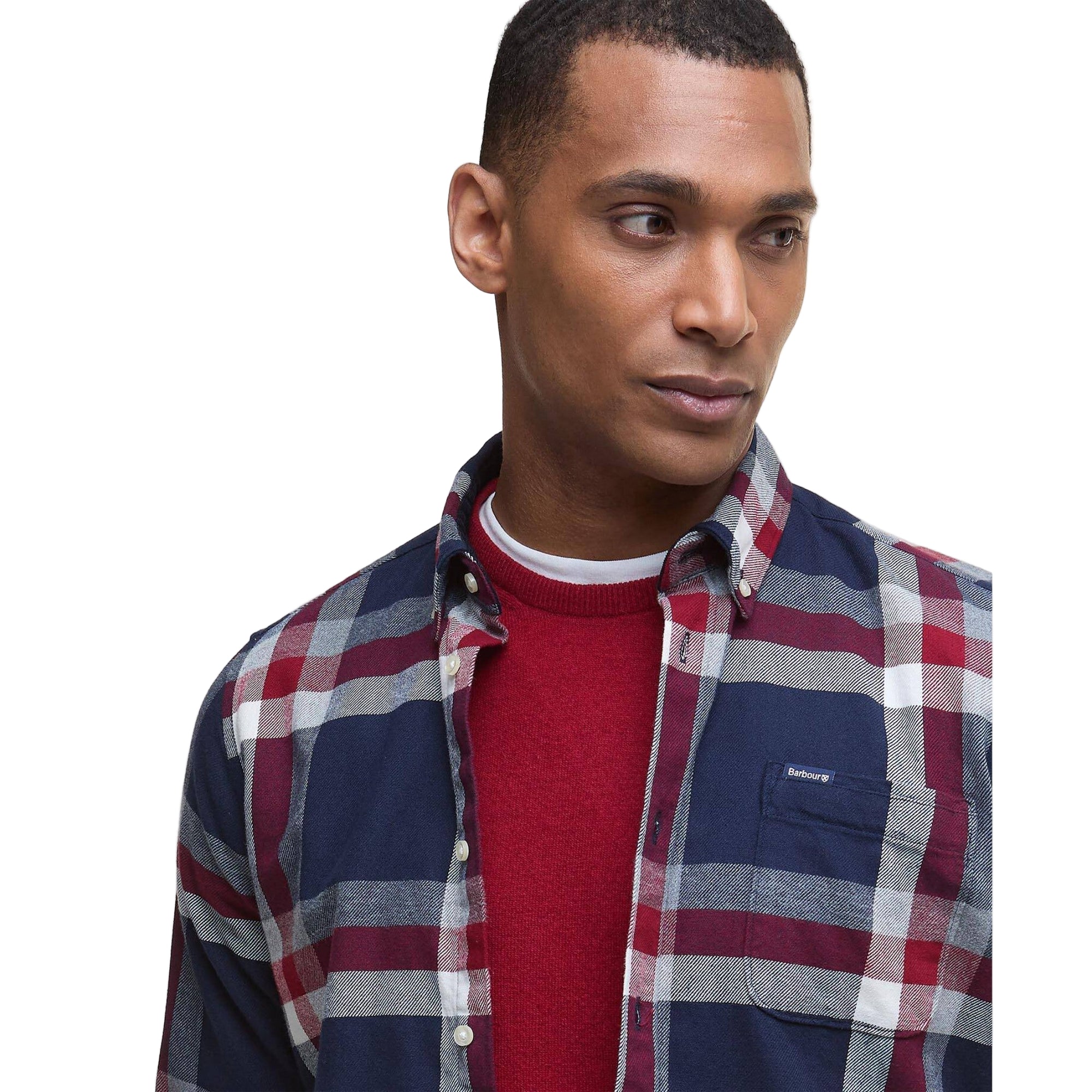 Man wearing a red and blue plaid shirt over a red sweater on a white background