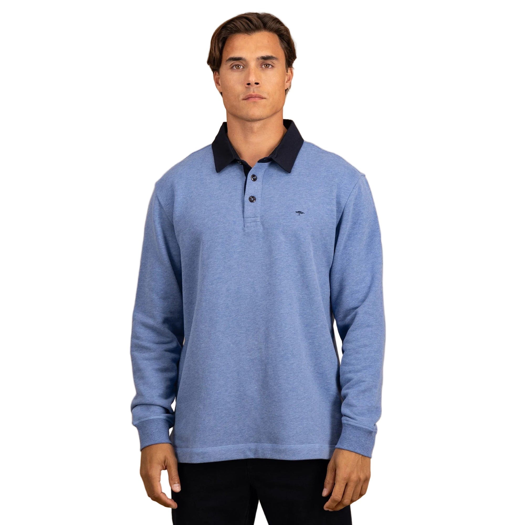 Man wearing a blue long-sleeve polo shirt with black collar against a beige background