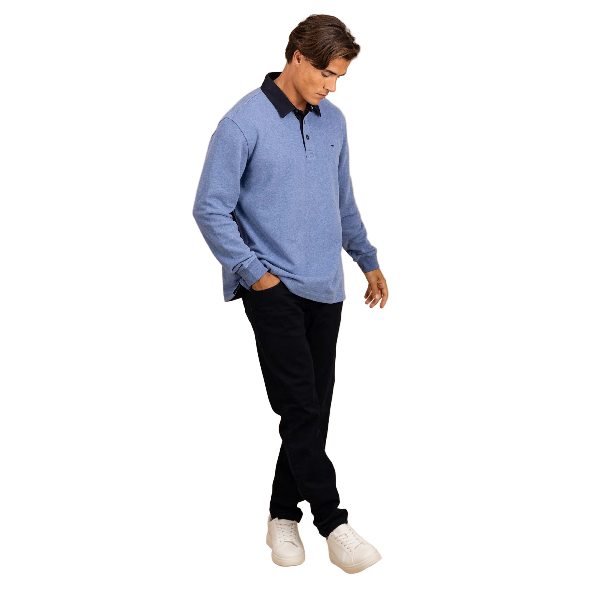 Man wearing a blue long-sleeve shirt with a black collar against a beige background