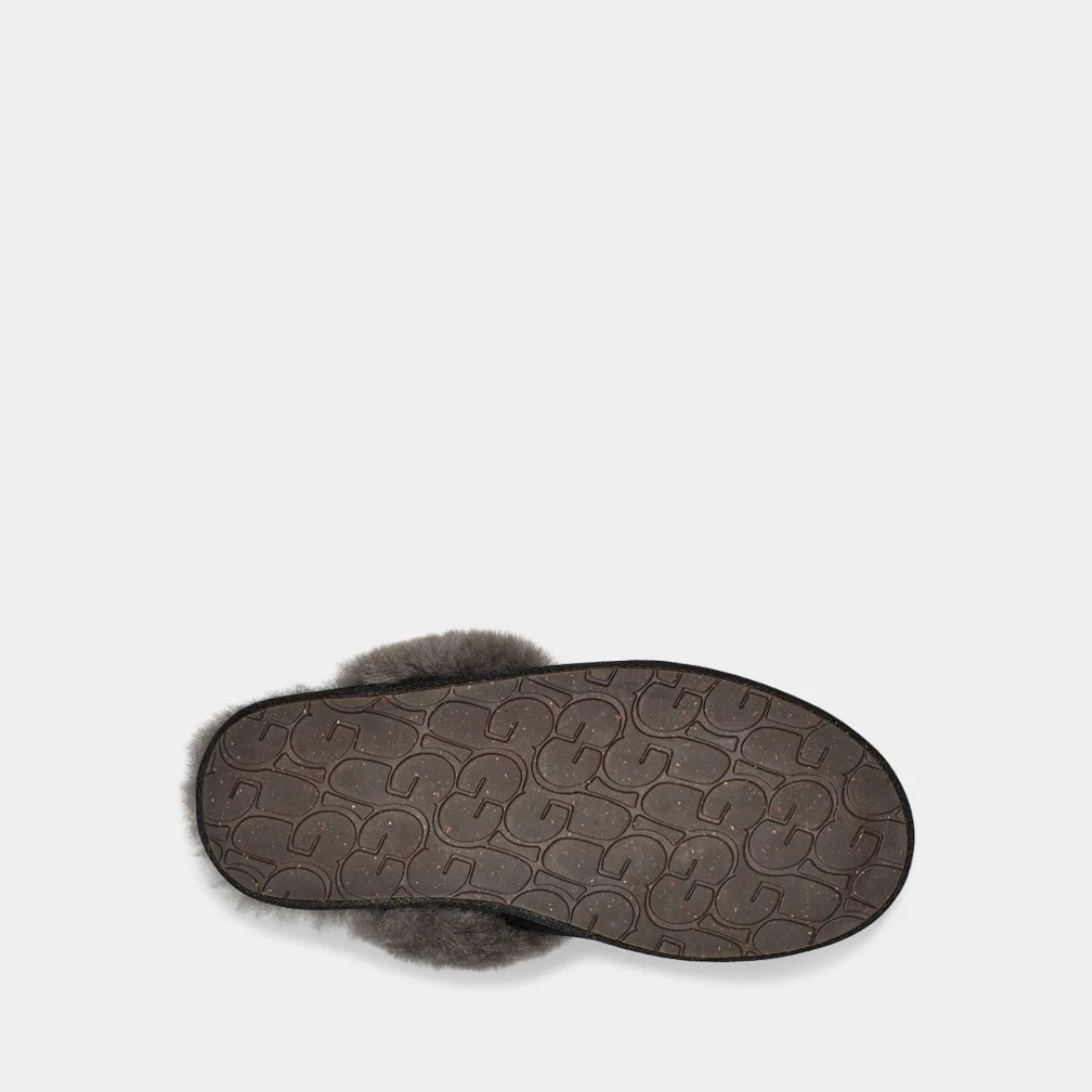Black UGG slipper with beige fur lining on a light gray background