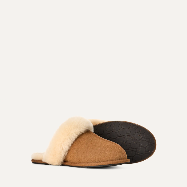 Brown slipper with beige fur lining on a white background