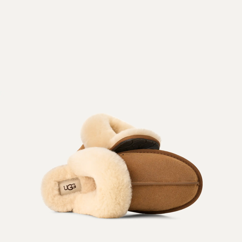 Pair of UGG slippers with beige fur lining on a white background