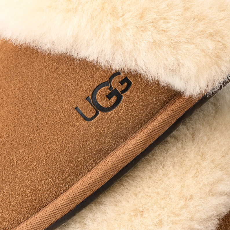 Close-up of UGG logo on a brown and beige fabric surface