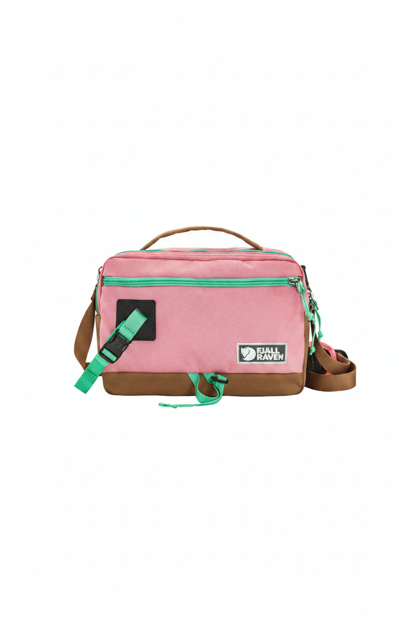 Pink bag with green accents and a visible brand logo on a white background