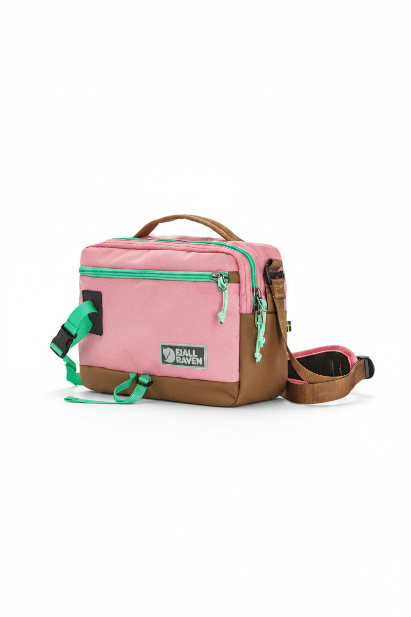 Pink and brown bag with green accents and Fjällräven logo on a white background