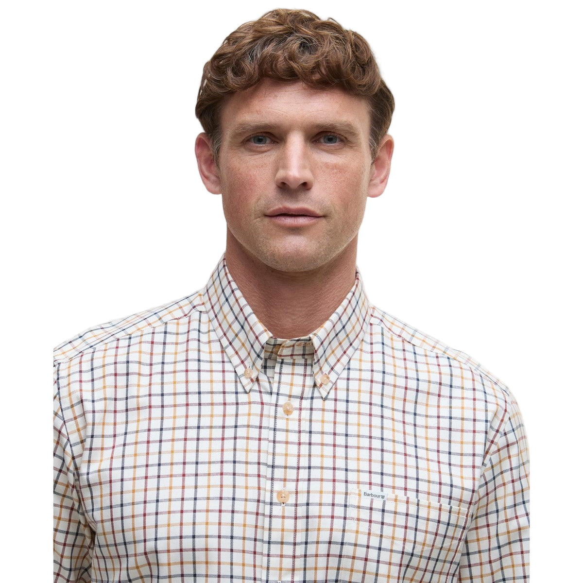 Man wearing a Barbour plaid shirt and brown pants on a white background