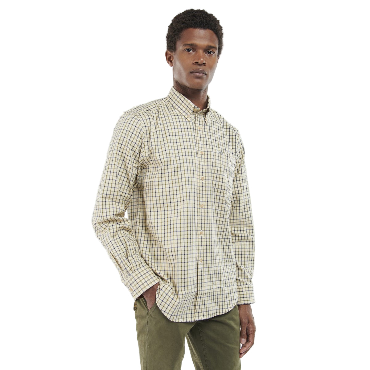 Man wearing a Barbour checkered shirt and green pants on a white background