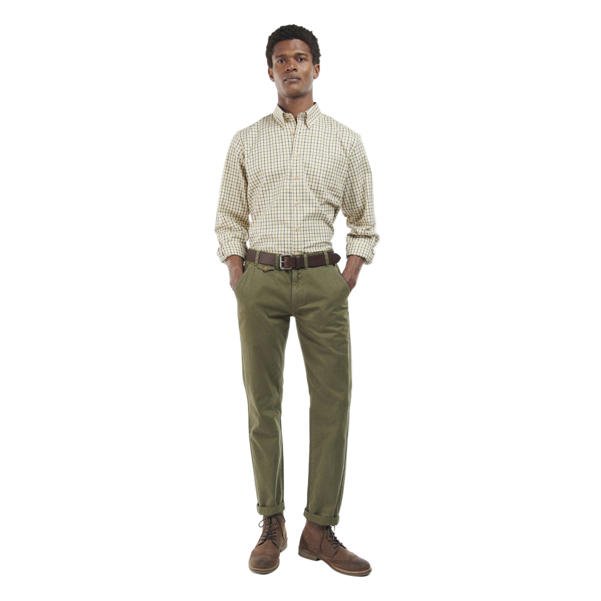 Man wearing a Barbour checkered shirt and green pants on a white background