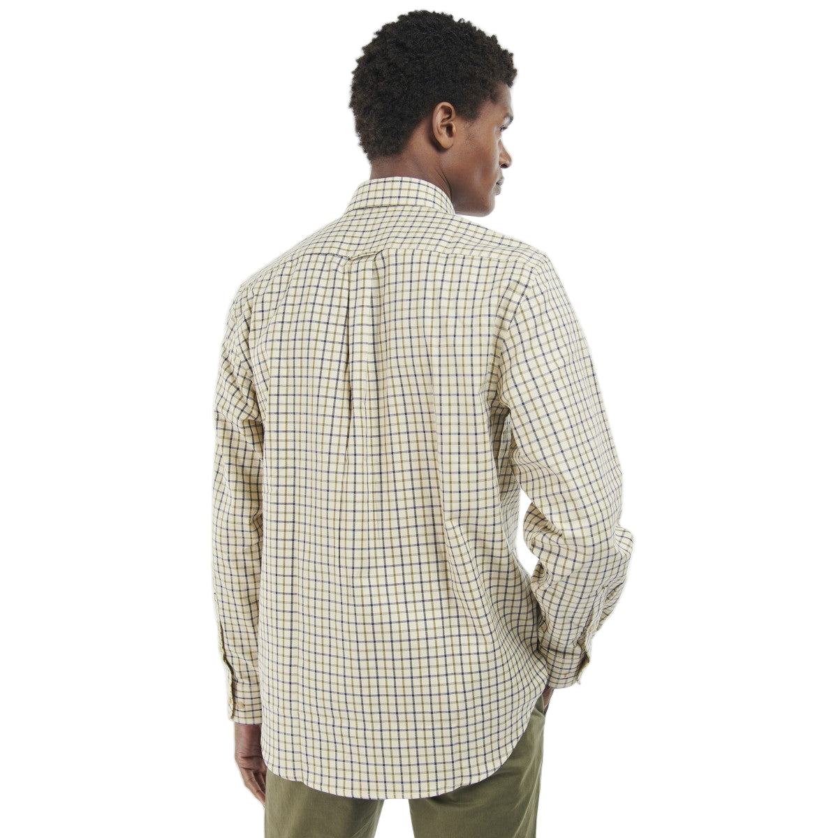 Man wearing a Barbour checkered shirt and green pants on a white background