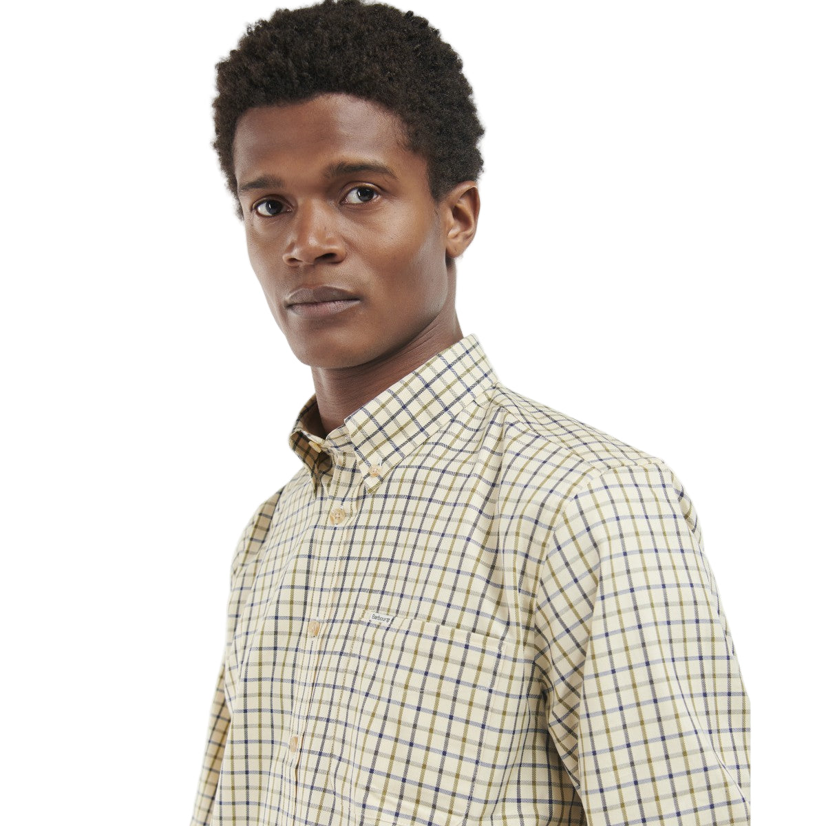 Man wearing a Barbour checkered shirt and green pants on a white background
