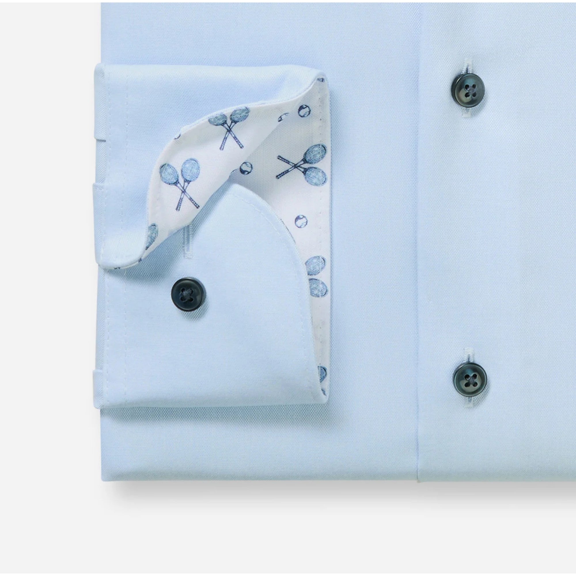 Light blue dress shirt with a folded white handkerchief featuring blue patterns on a light blue background