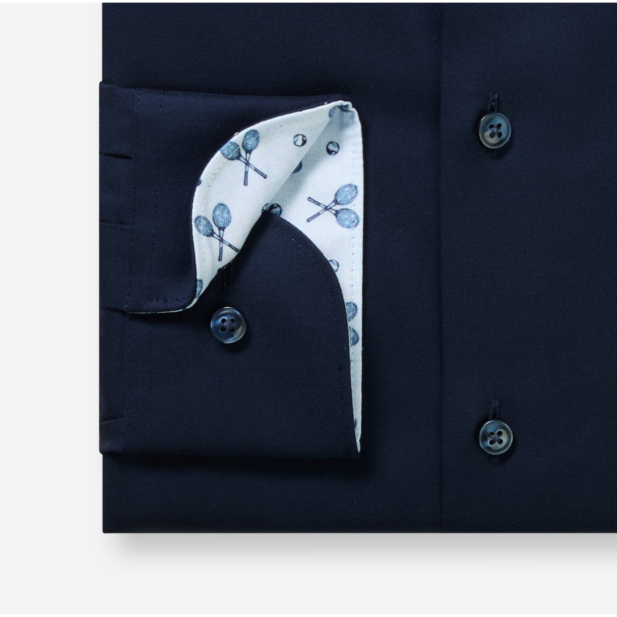 Navy blue shirt with a white pocket square featuring blue patterns on a white background