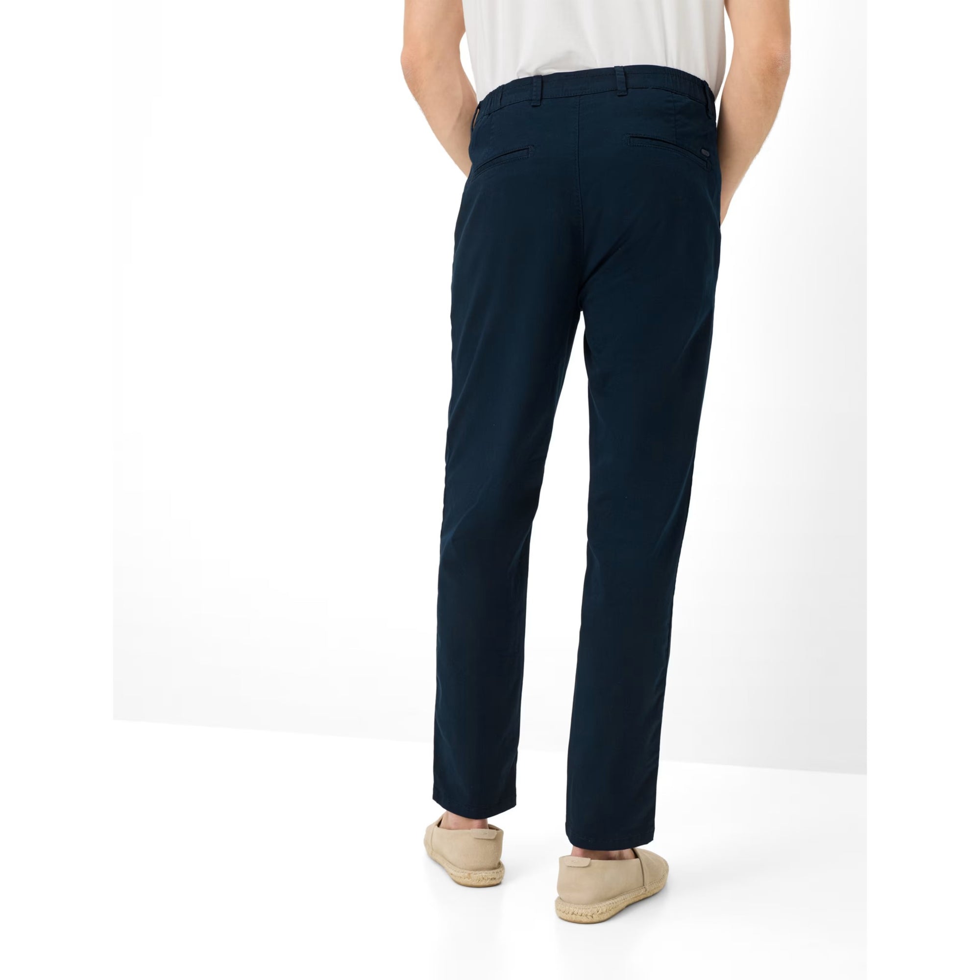 Person wearing navy pants on a white background