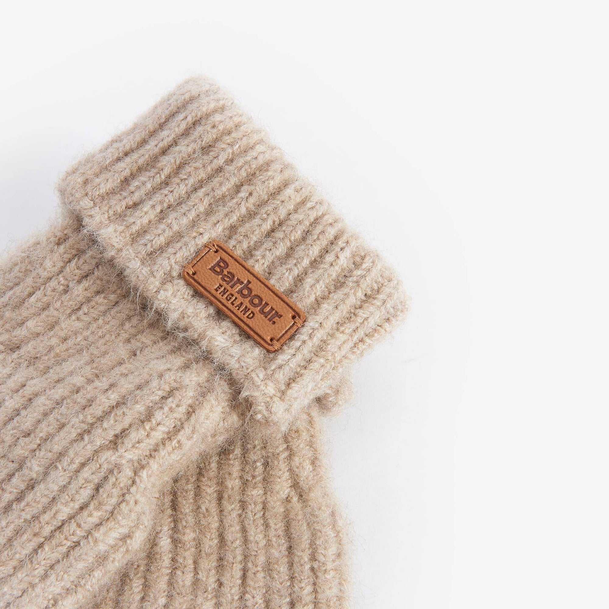 Beige knitted glove with a Barbour logo on a white background