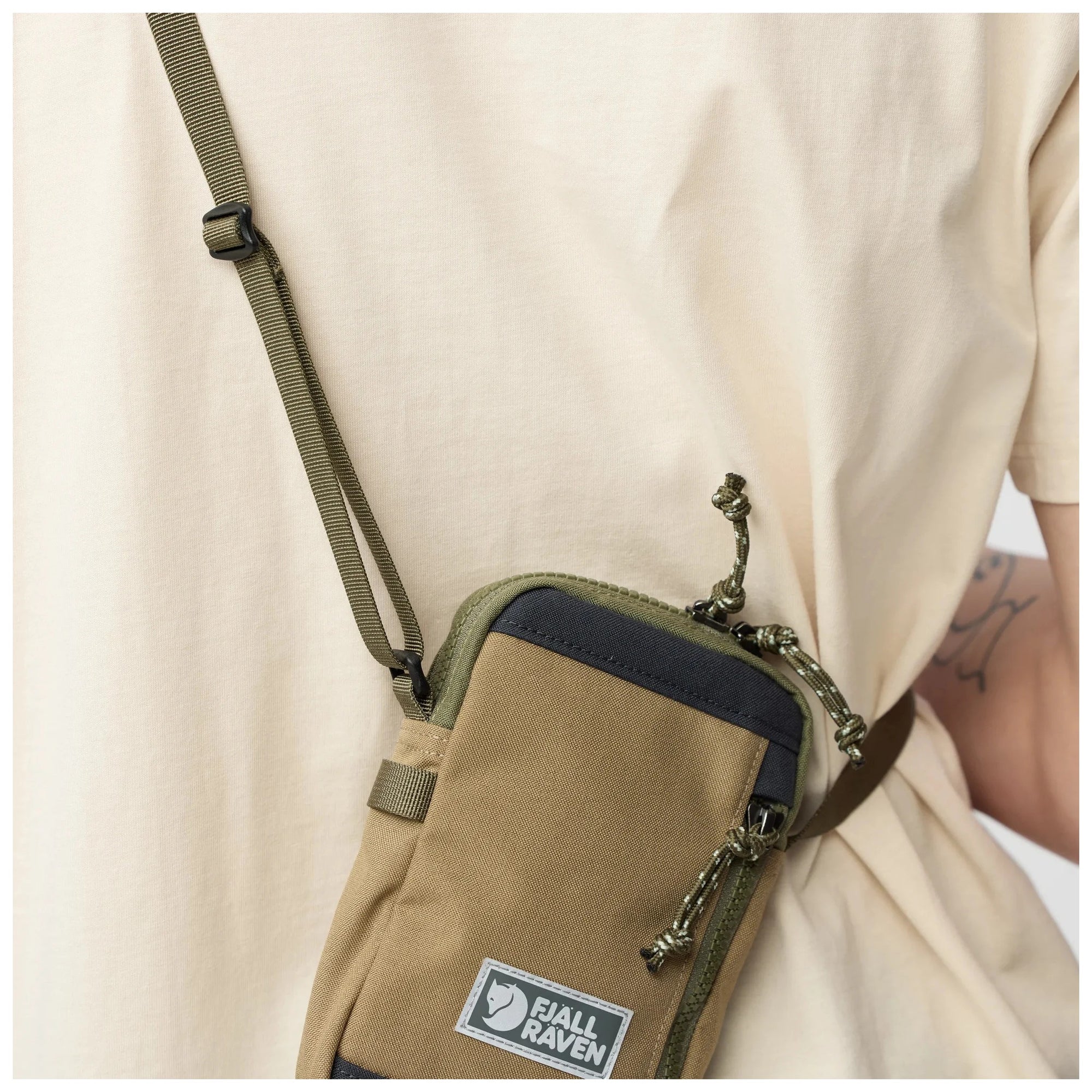 Green-Clay crossbody bag with a visible brand logo on a neutral background