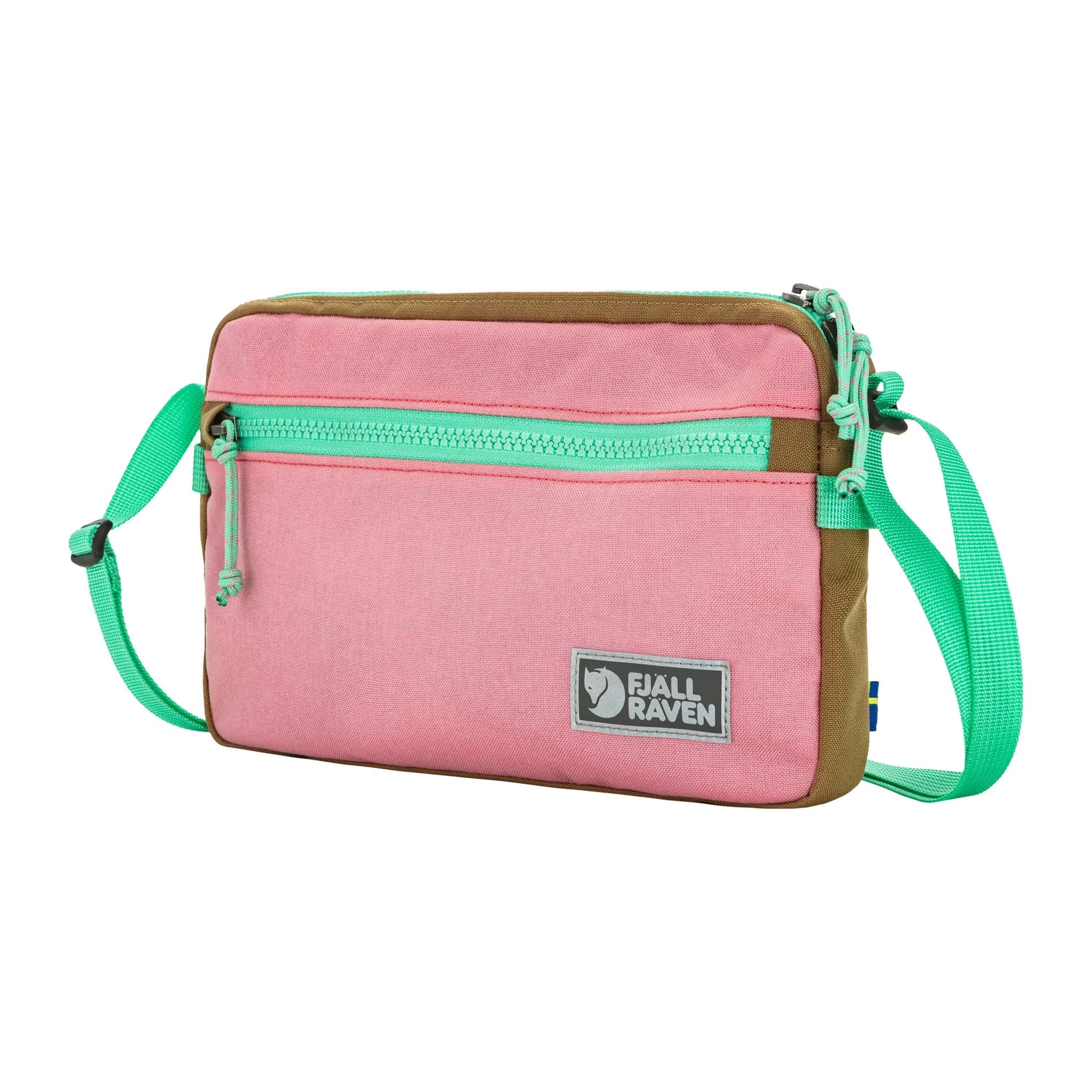 Pink crossbody bag with green strap and brown accents on a white background