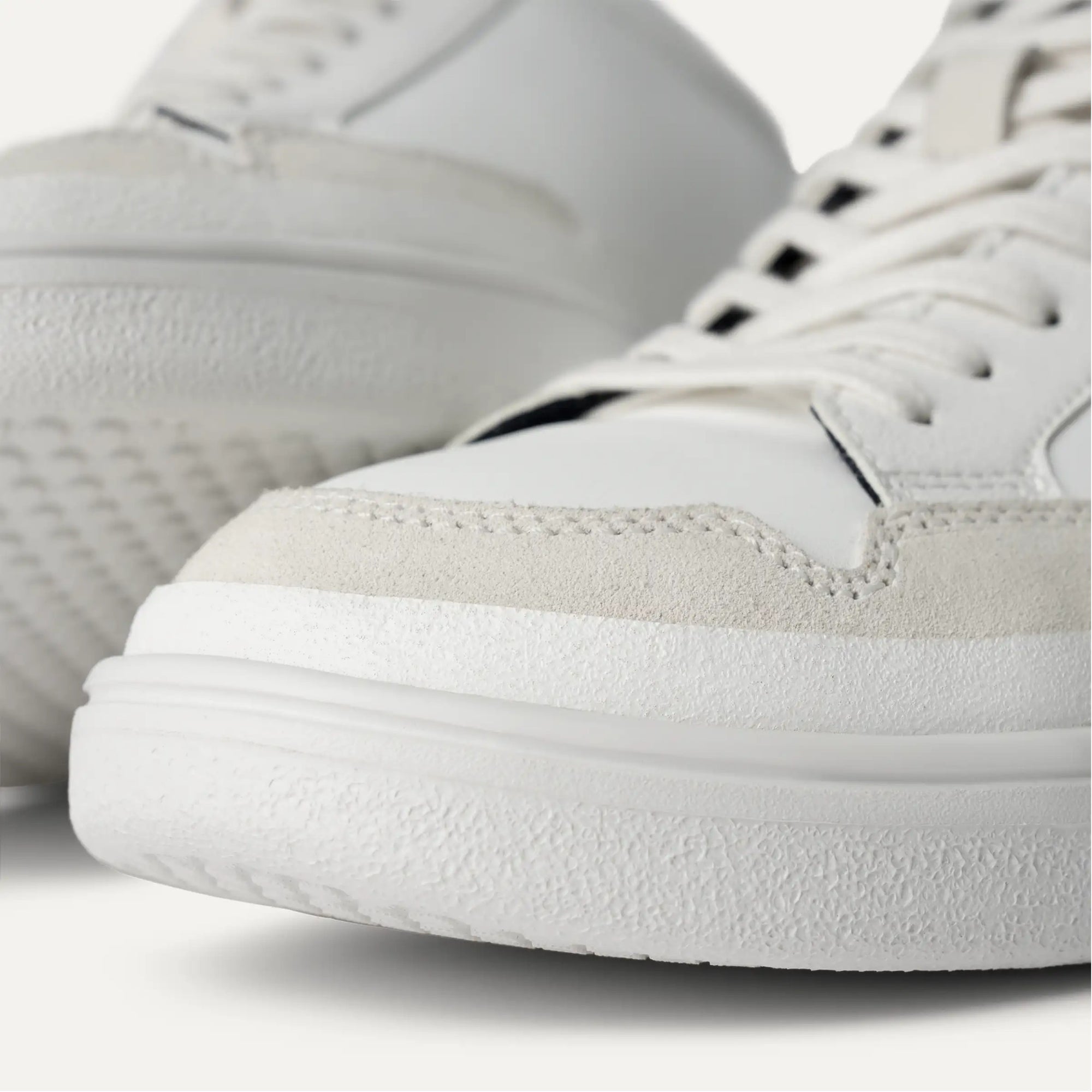 A white UGG South Bay Low Trainer sneaker with lace-up closure and a rubber outsole.