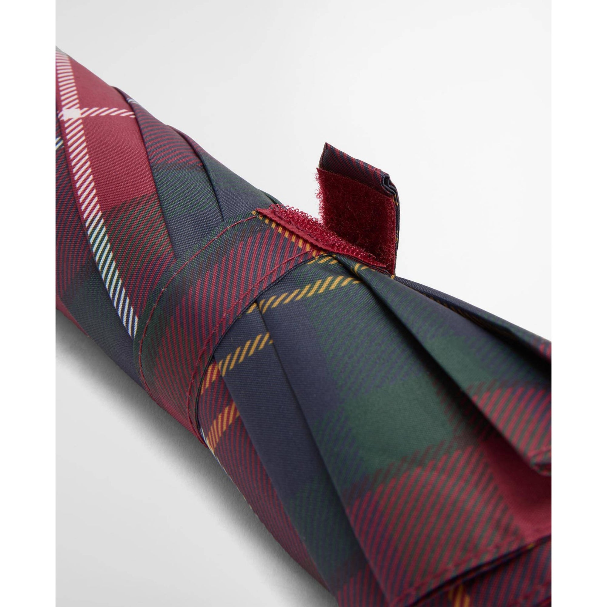 Plaid fabric with a mix of red, green, and blue colors on a white background