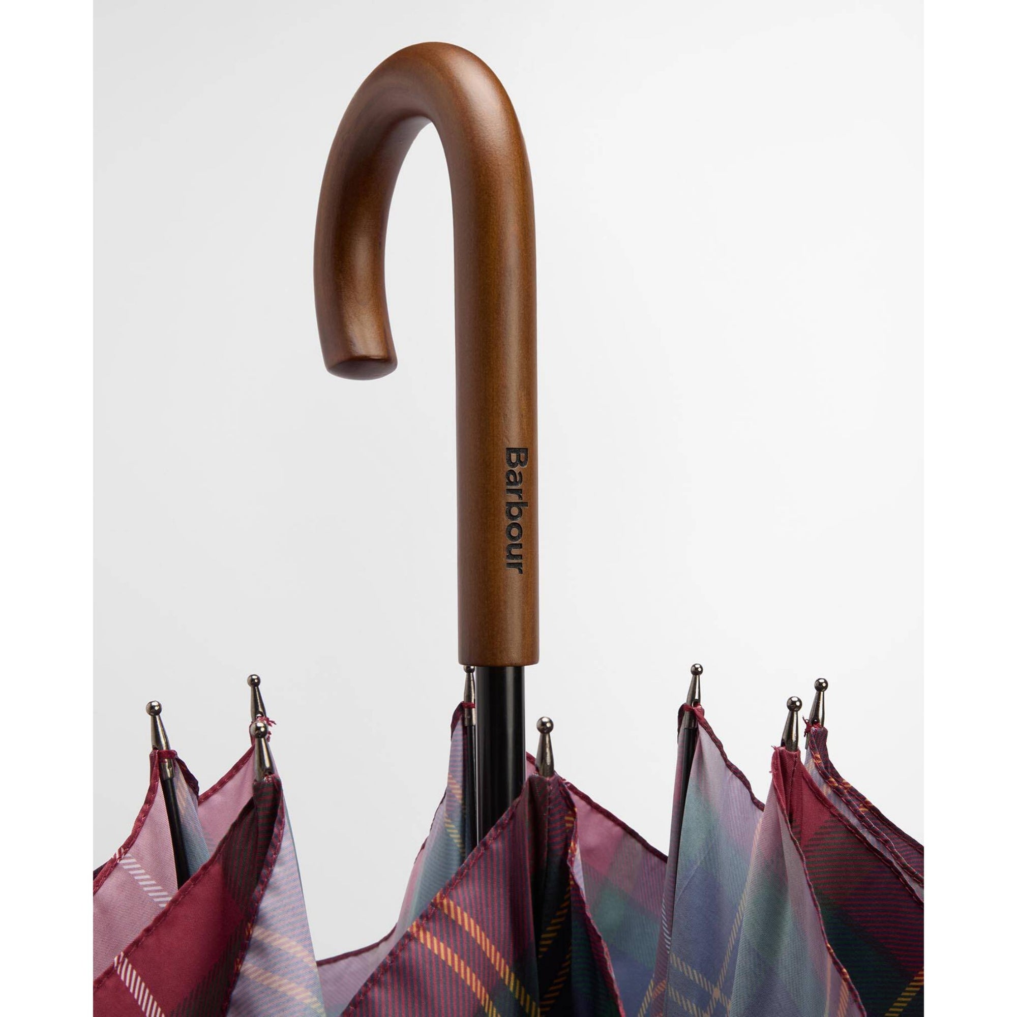 Brown umbrella handle with 'Barbour' branding against a white background