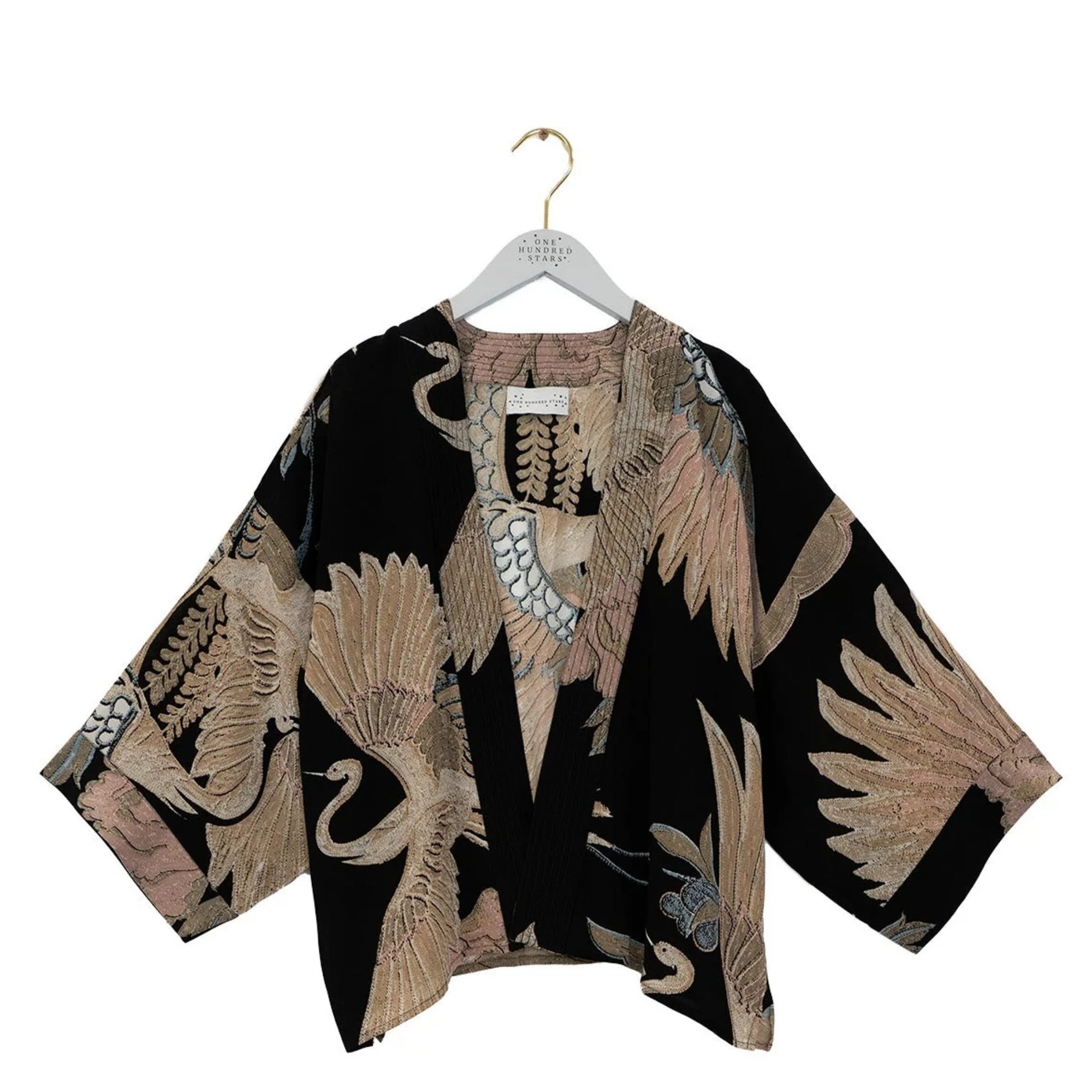 Black kimono-style garment with beige floral patterns on a white hanger against a white background