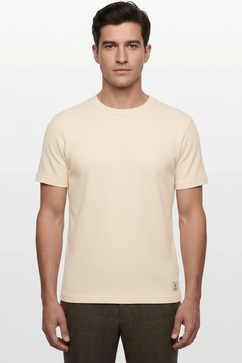 Man wearing a beige t-shirt on a white background