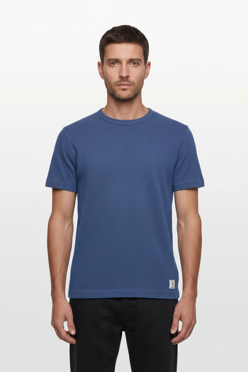Man wearing a blue t-shirt on a white background