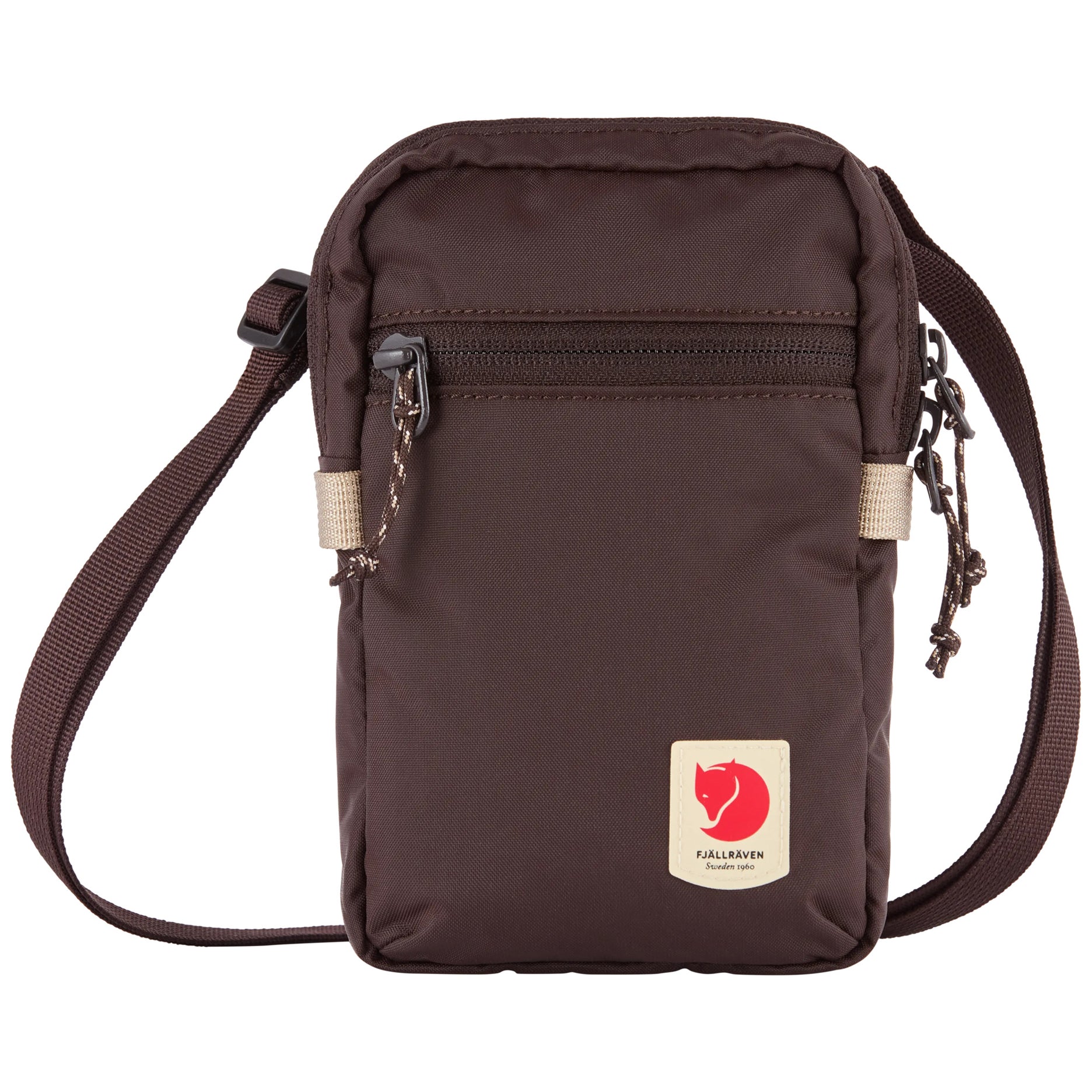 A dark brown Fjällevaren crossbody bag with a front zippered pocket, adjustable shoulder strap, and the brand's signature red fox patch on a white background.
