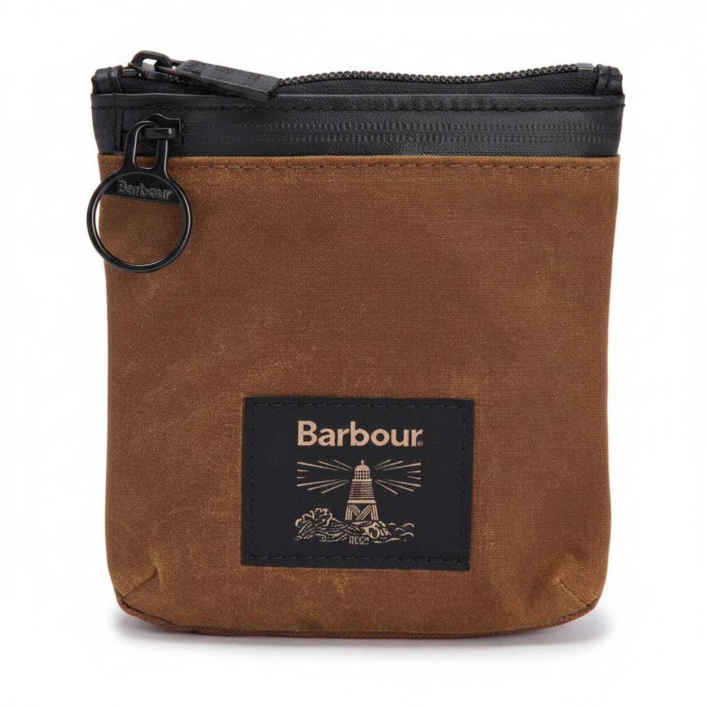 Close-up of a brown waxed canvas pouch with a black zipper, a metal key ring, and a black Barbour brand patch on the front.